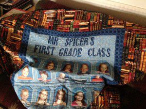 A gift from grateful parents: a quilt featuring a border of books and the names and photos of the students.