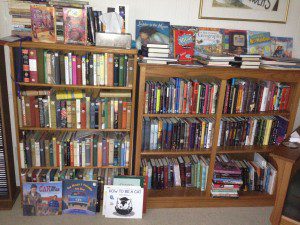 Bookcases with winners of the Newbery and Printz medals, with autographed copies of other books on top.