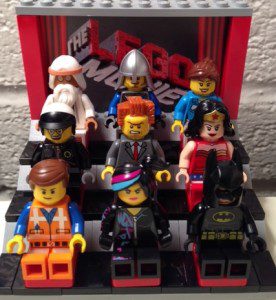 LEGO Movie characters, from a collector can sent by the studio, settle in for a screening. Lord Business is not happy that is view is blocked by Wyldstyle's hair.