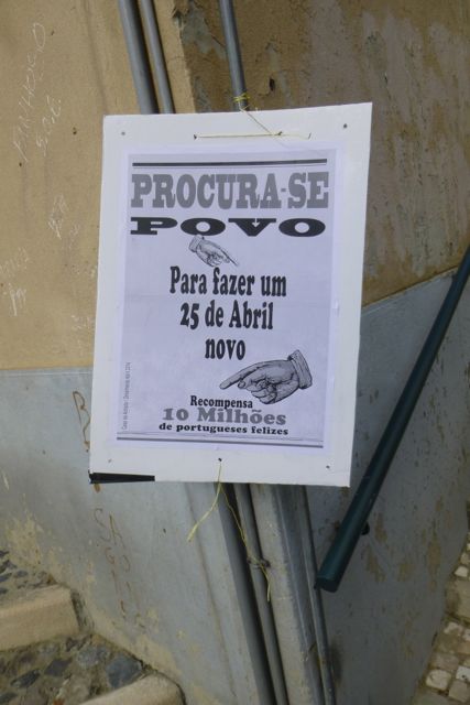 A sign posted throughout downtown Lisbon reads, "Wanted: People to make a new April 25. Salary: 10 million happy Portuguese."