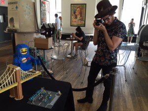 A professional photographer from the PR company associated with the LEGO Brickumentary at the Angelika Film Center.