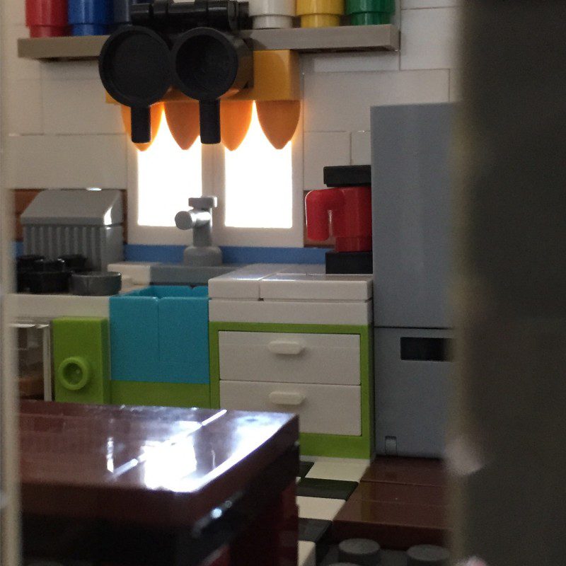 The kitchen, seen from the front door. It came from the Painting Easter Eggs set that I modified and built into the MOC wall.
